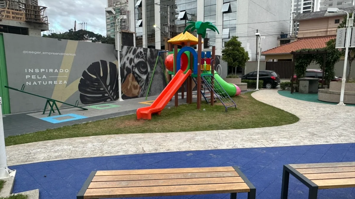 Parque infantil de constructora en Meia Praia con bancos y columpios